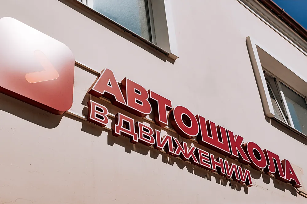 Вывеска «Автошкола В движении» на здании